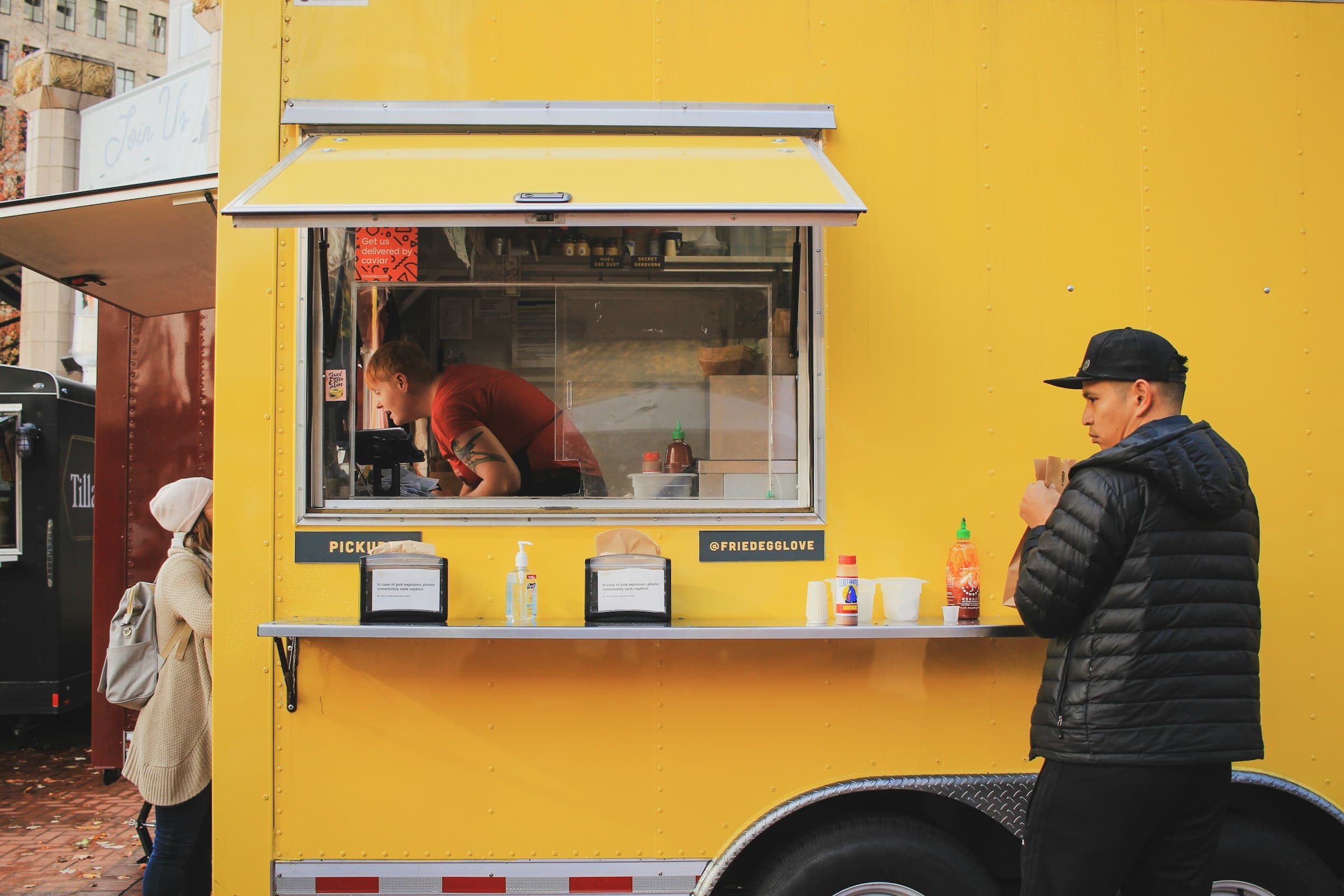 A customer ordering at a food truck